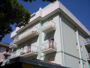 a white building with balconies on the side of it at Condominio York in Lido di Jesolo