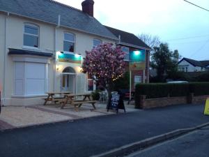 a house with a picnic table and a sign in front of it at Seashells Beach Hotel in Sutton on Sea