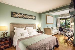 a bedroom with a large bed and a living room at Hotel Villa Linneo in Rome