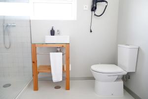a bathroom with a toilet and a sink and a shower at City's Hostel Ponta Delgada in Ponta Delgada