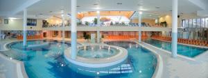 a large swimming pool in a large building at Glamping SUN VALLEY Bioterme in Mala Nedelja