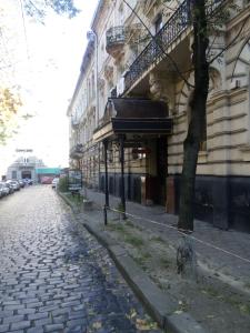 a cobblestone street in front of a building at Mini Hotel Central Park in Lviv