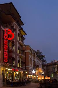 a building with a red sign on the side of it at 8 1/2 Art Guest House in Plovdiv