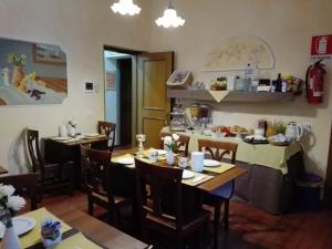 a restaurant with tables and chairs in a room at Relais Dante e Beatrice in Florence