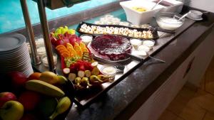a buffet of food on a counter with fruits and vegetables at Arena Mar Hotel and SPA in Golden Sands
