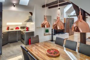 a kitchen and dining room with a wooden table and chairs at Michalská 2 - Old Town Apartment in Prague