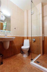 a bathroom with a toilet and a sink at Bright House in Plovdiv