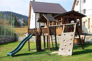 a playground with a slide and a gazebo at Pensiunea Vraja Muntelui in Arieşeni