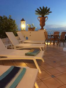 a patio with chairs and a table with a view at Palazzo Marzoli charme Resort - Small Luxury Hotel in Positano