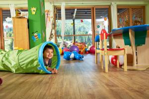 a young child is playing in a play room at Almhof Family und Wellness Resort in Gerlos