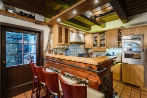 a kitchen with a wooden counter and some chairs at Medvědí skála in Čeladná +40 photos