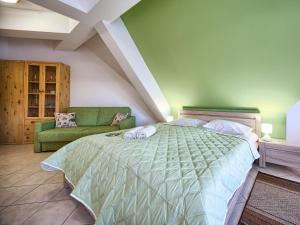 ザコパネにあるVisitZakopane - Avocado Apartmentのベッドルーム(大型ベッド1台、緑のソファ付)