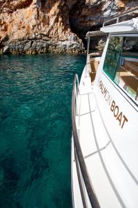a boat in the water next to a cave at Palmon Bay Hotel & Spa in Herceg-Novi