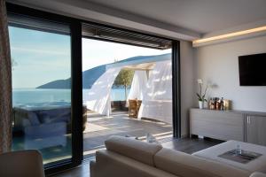 a living room with a view of the ocean at Palmon Bay Hotel & Spa in Herceg-Novi