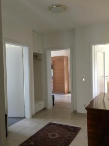 an empty living room with two doors and a hallway at FeWo Rheine Stadtzentral in Rheine