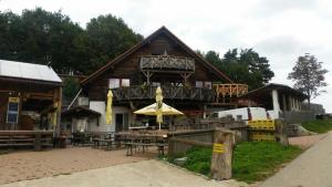 a building with a deck with tables and chairs at Gradlhof in Postbauer-Heng