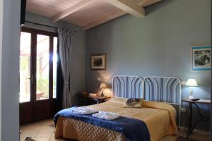 a bedroom with a bed with blue walls at Santa Igia - Country House in Cagliari