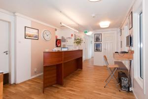 a room with a desk and a clock on the wall at Stavanger Bed & Breakfast in Stavanger