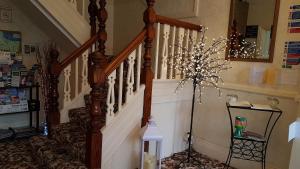 a hallway with a stairway with a spiral staircase at Agar House in Llandudno