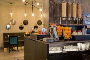 a kitchen filled with lots of fruits and vegetables at Best Western Plus CHC Florence in Florence