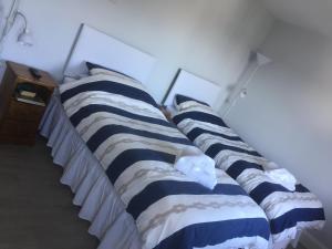 a row of pillows on a bed in a room at The Red Lion Inn in Dittisham