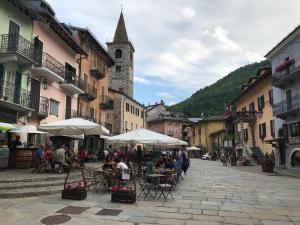un grupo de personas sentadas en mesas en una calle en Little Limone, en Limone Piemonte