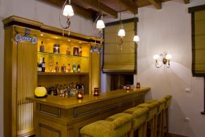 a bar with a row of stools in a room at Methexis Boutique Hotel in Dimitsana