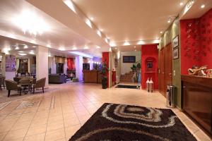 a lobby with red walls and a living room at Boutique Hotel Parnassia in Arachova