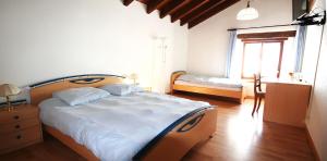 a bedroom with a large bed and a window at Le Cerneux-au-Maire in Les Bois