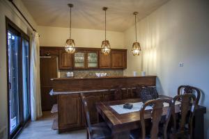 a kitchen with a table and some lights at Petra house in Arachova