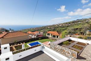 a villa with a view of the ocean at OurMadeira - Casa das Orquídeas, sunny location in Calheta