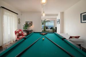 a pool table in a living room with a pool table at OurMadeira - Casa do Júlio, Calheta beach view in Calheta