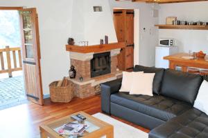 a living room with a couch and a fireplace at OurMadeira - Casa de Campo, countryside in Porto Moniz