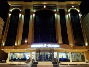 a large building with a staircase in front of it at Swiss Blue serviced Apartments- Al Zahra in Jeddah