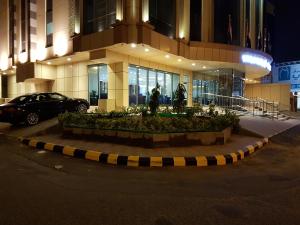 a car parked in front of a building at night at Swiss Blue Hotel Al Zahra in Jeddah