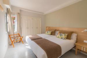 Posteľ alebo postele v izbe v ubytovaní Hotel LIVVO Koala Garden