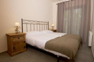 Кровать или кровати в номере Apartaments Rural Montseny