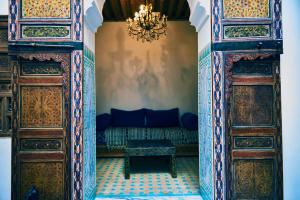 an entrance to a room with a couch and a chandelier at Dar Saida in Fès