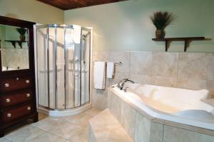 a large bathroom with a tub and a shower at Chalet 01 Chemin Blanc by Les Chalets Alpins in Stoneham +35 photos
