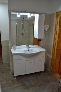 a bathroom with a white sink and a mirror at Casa Fanarilor in Braşov +58 photos
