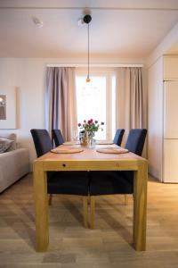 a dining room table with blue chairs and a dining room at Arctic Railway City Suite in Rovaniemi