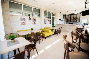 a restaurant with tables and chairs and a bar at Court Inn in Panagyurishte