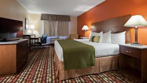 a hotel room with a bed and a television at Best Western Ambassador Inn & Suites in Wisconsin Dells +37 photos