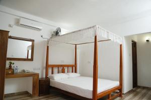 En eller flere senge i et værelse på Aloy's Residence