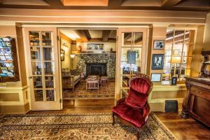 a living room with a fireplace and a red chair at Kangaroo House Bed & Breakfast in Eastsound