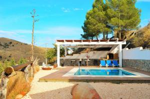 a house with a swimming pool in a yard at Cortijo Claudia in Taberno