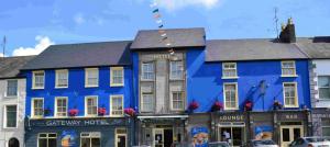 a blue building on the corner of a street at The Gateway Hotel in Swinford