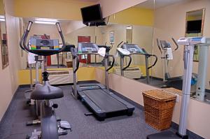 a hospital room with several machines and a mirror at Super 8 by Wyndham Irving/DFW Apt/North in Irving