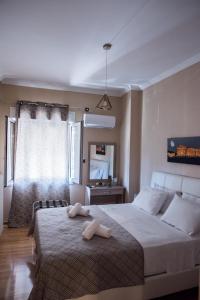 a bedroom with a large bed with two towels on it at Gazi Divine Apartment in Athens