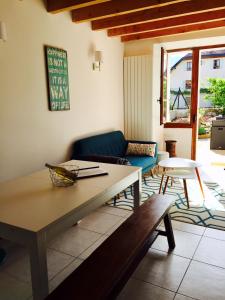 a living room with a couch and a table at Maison de charme " Les Cyclamens" in Saint-Jorioz